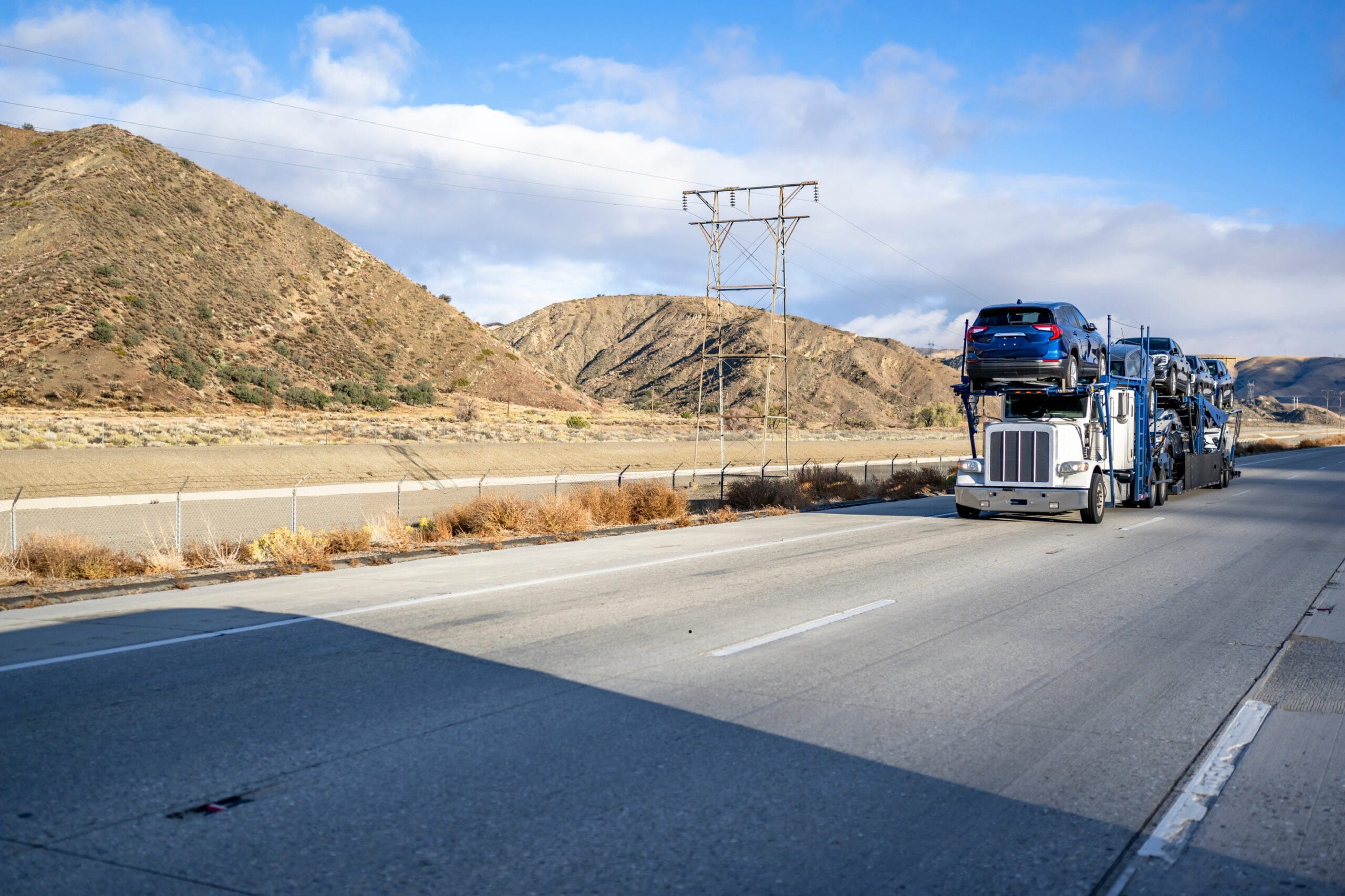 Car carrier transporting vehicles along a highway